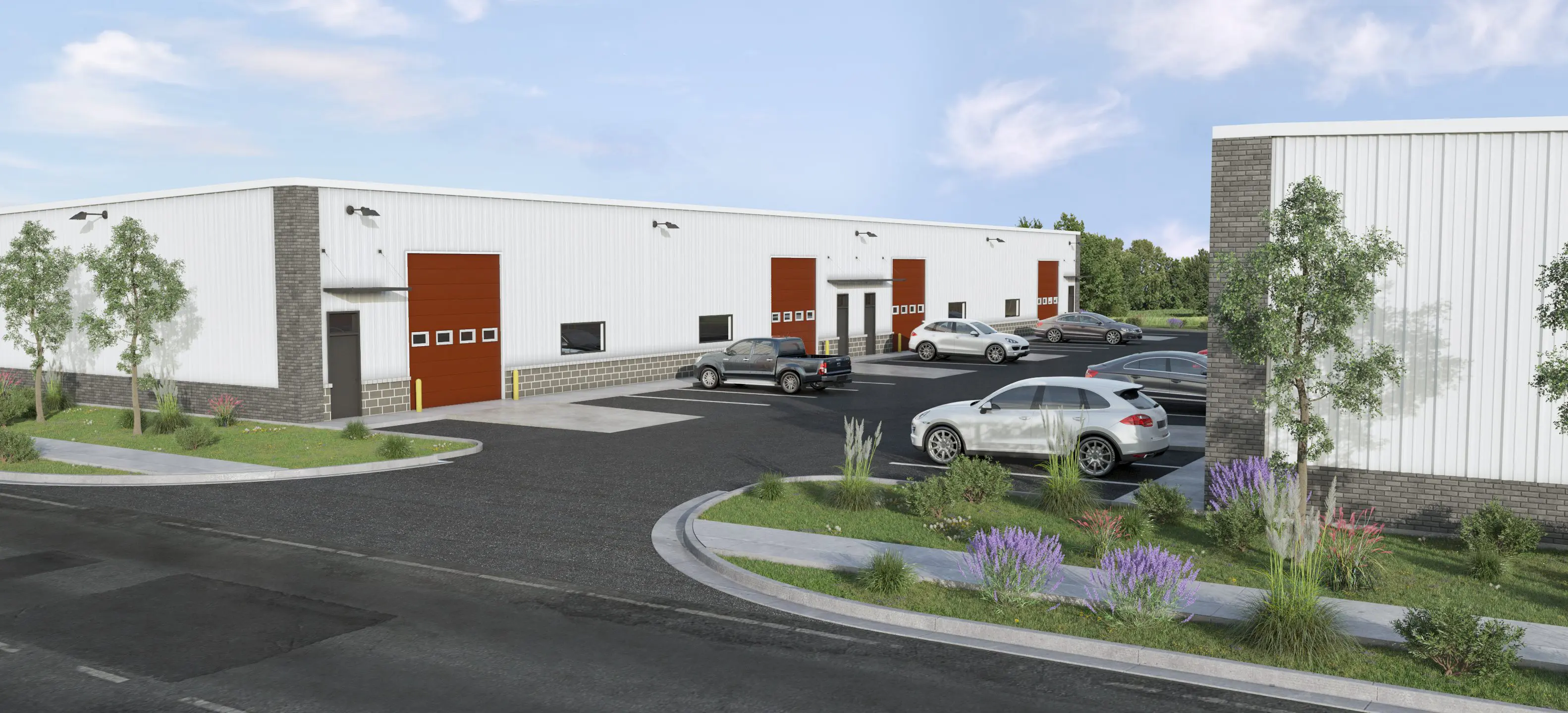 Modern industrial warehouse with loading docks and parked vehicles.